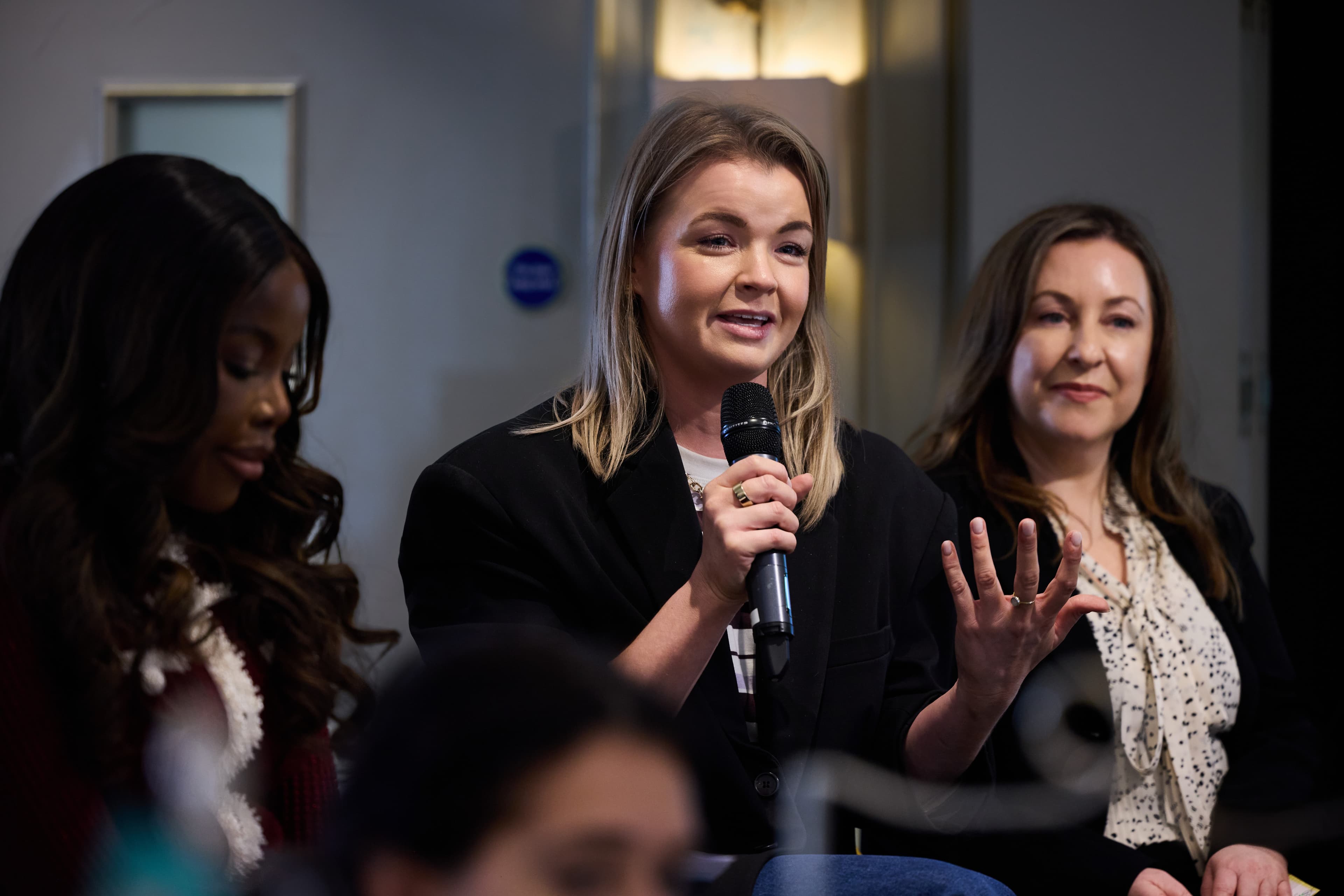 Panel discussion at Revieve's London beauty industry event, a speaker gesturing while answering a question